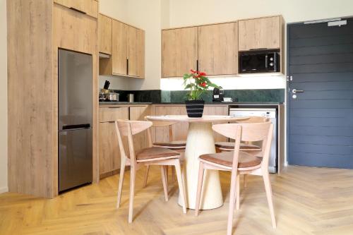 a kitchen with a table and chairs in a kitchen at Hyatt House Johannesburg Rosebank in Johannesburg