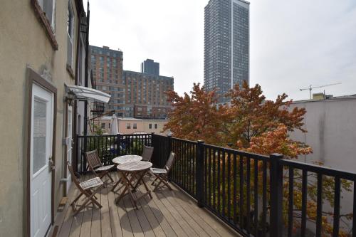 a balcony with a table and chairs on a building at Riverhouse Extended Stay Apartment in Jersey City