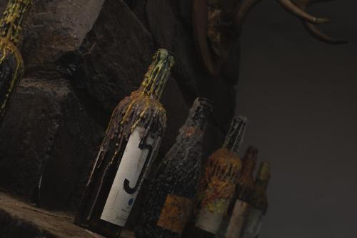 a group of bottles sitting on a ledge at Hotel Posada las Nubes in Parras de la Fuente