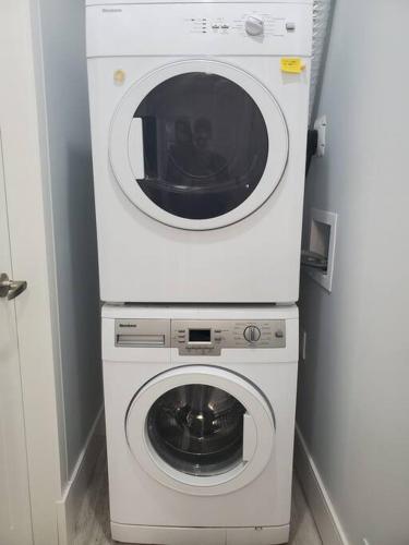 a white washer and dryer in a room at Cozy Guest Suite in Quiet Home with Private Entry in Vancouver