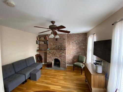 a living room with a couch and a fireplace at Riverhouse Extended Stay Apartment in Jersey City