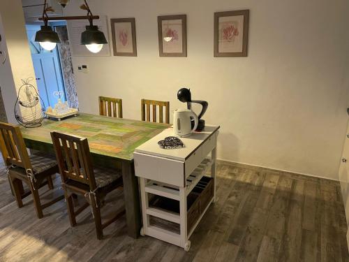 a kitchen with a table with a tea kettle on it at Krk Houses in Kornić