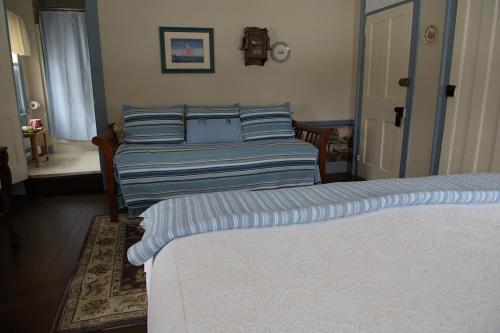 a bedroom with two beds with blue pillows at Shoreham Inn Bed & Breakfast in Shoreham