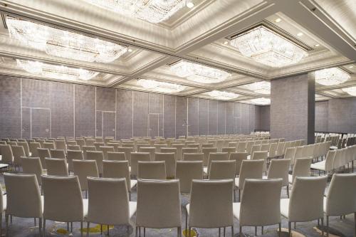 an empty room with rows of chairs in it at Park Lane New York in New York