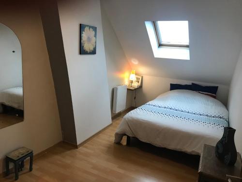 a bedroom with a white bed and a window at citesteloi in Friville-Escarbotin
