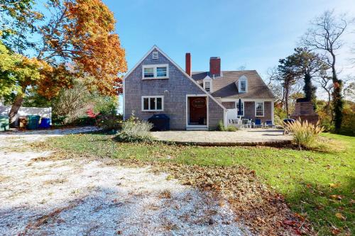 a house with a driveway in front of it at Pleasant Bay Retreat in Orleans