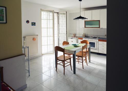 een keuken met een tafel en stoelen in een kamer bij Merola Sisters Holiday Home in Caserta