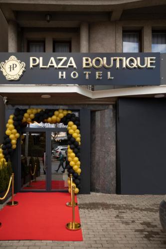 a hotel entrance with a red carpet and a sign at Plaza Boutique Hotel in Pristina