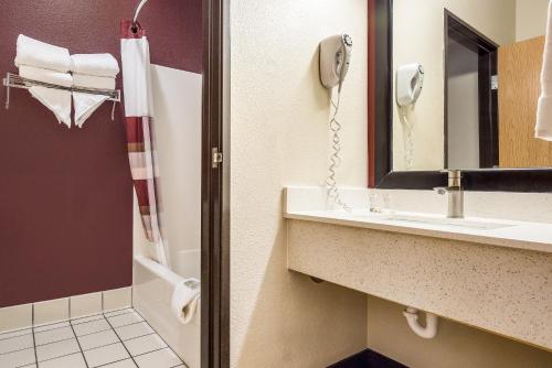 a bathroom with a sink and a phone at Red Roof Inn St Louis - Troy, IL in Troy