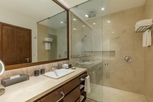 a bathroom with a sink and a shower at Camino Real Mérida in Mérida
