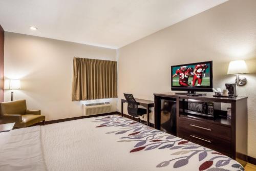 a hotel room with a bed and a flat screen tv at Red Roof Inn St Louis - Troy, IL in Troy