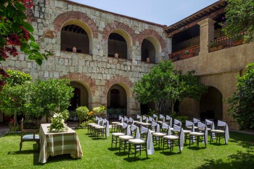 a courtyard with tables and chairs in front of a building at Quinta Real Oaxaca in Oaxaca City