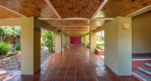 an empty hallway of a building with a ceiling at Camino Real Guadalajara in Guadalajara