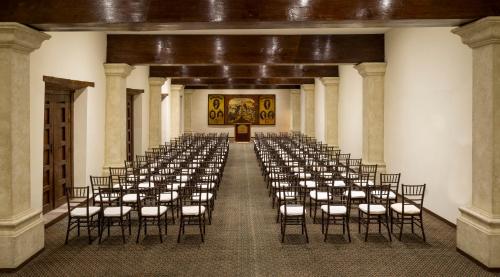 a room with rows of chairs in a building at Quinta Real Zacatecas in Zacatecas