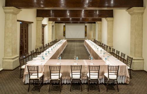 a large banquet hall with a long table with chairs at Quinta Real Zacatecas in Zacatecas