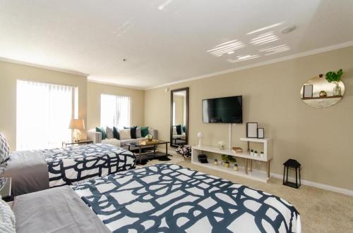 a large bedroom with two beds and a tv at Loft apartments at Hollywood FREE parking close to Studios Universal in Los Angeles