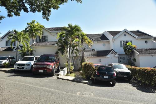 a group of cars parked in front of a house at Barbican cozy Flat at dillsbury in Kingston