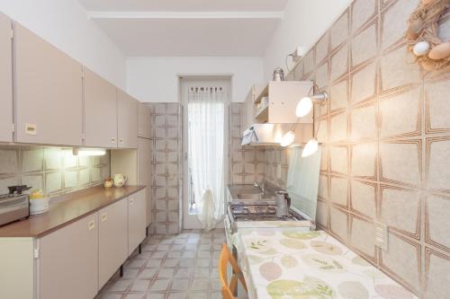 a kitchen with white cabinets and a counter top at Casa di Gioia in Verona
