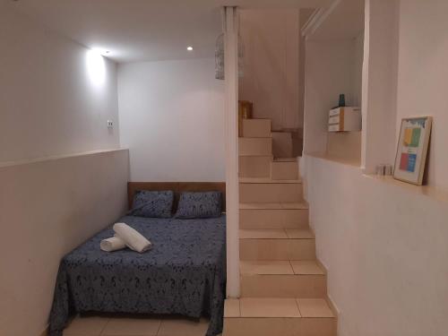 a small bedroom with a bed and a staircase at 06 DUPlEX LOFT in Barcelona