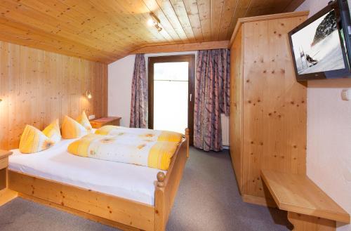 um quarto com uma cama e uma televisão num quarto em Appartement Jägerhof em Sölden