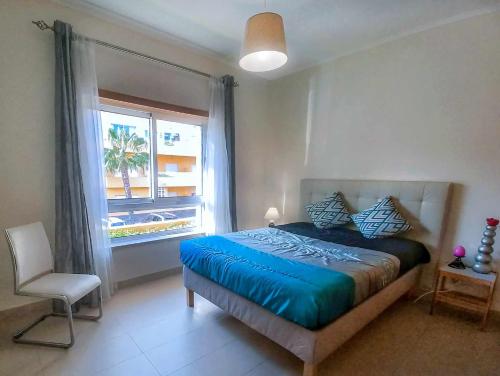 a bedroom with a large bed and a window at Apartamento Margarida Royal Cabanas Golf By Your Home Algarve in Tavira