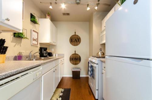 a kitchen with white cabinets and a refrigerator at Savana spectacular loft in Los Angeles