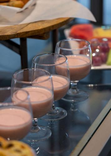 four wine glasses filled with a pink drink at Radisson Blu Hotel & Residence Maputo in Maputo