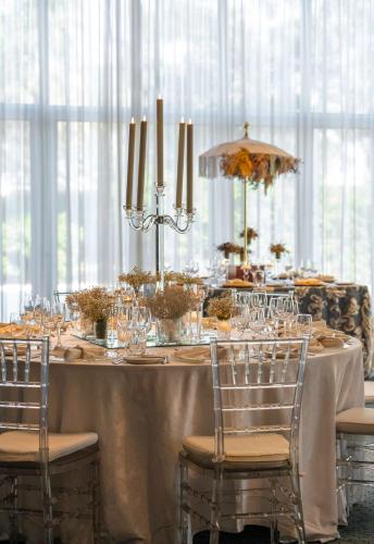 a long table with chairs and a table with glasses at Radisson Blu Hotel & Residence Maputo in Maputo