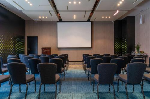 a conference room with chairs and a projection screen at Radisson Blu Hotel & Residence Maputo in Maputo