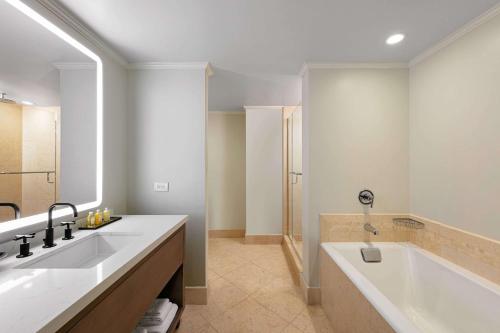 a bathroom with two sinks and a bath tub at The Royal Sonesta Chicago Downtown in Chicago