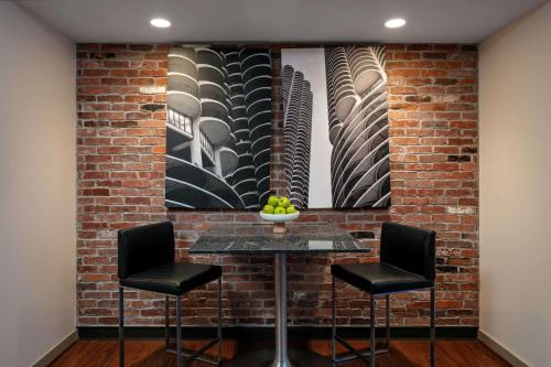a brick wall with a table and two chairs at The Royal Sonesta Chicago Downtown in Chicago