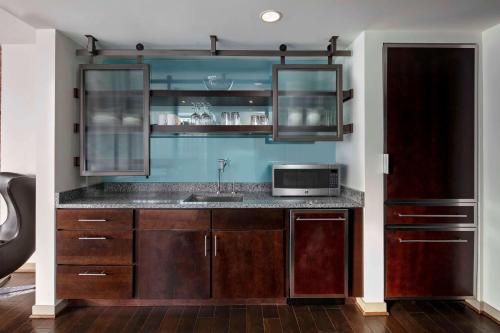 a kitchen with a sink and a microwave at The Royal Sonesta Chicago Downtown in Chicago