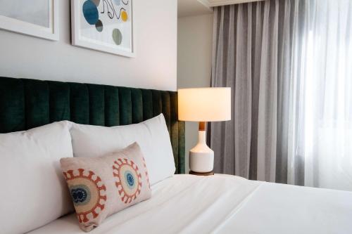 a bedroom with a bed with a pillow and a lamp at The Royal Sonesta Chicago Downtown in Chicago
