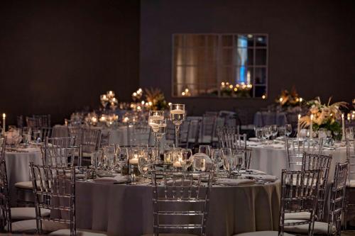 a room full of tables with white tablecloths and chairs at The Royal Sonesta Chicago Downtown in Chicago