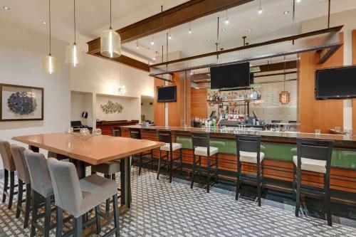 a restaurant with a table and chairs and a bar at The Royal Sonesta Chicago Downtown in Chicago