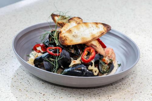 a bowl of food with vegetables and toast on top at The Royal Sonesta Chicago Downtown in Chicago
