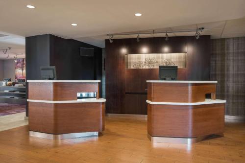 a lobby with two reception desks in a building at Sonesta Select Los Angeles LAX El Segundo in El Segundo