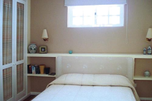 a bedroom with a bed with a window above it at Holiday Home bei Viana do Castelo Carreco - PON03016-F in Carreço