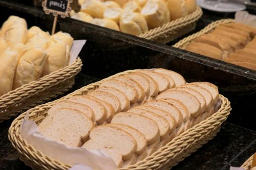 a display of breads and other baked goods in baskets at DOM Barra Hotel in Rio de Janeiro