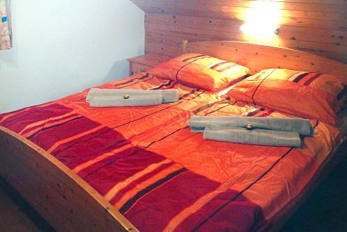 a large wooden bed with two bags on it at Feriendorf am Feuerkogel, Ebensee in Ebensee