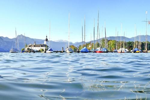 a group of sailboats are docked in a harbor at Feriendorf am Feuerkogel, Ebensee in Ebensee