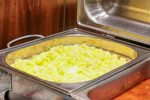 a pan filled with food in an oven at DOM Barra Hotel in Rio de Janeiro