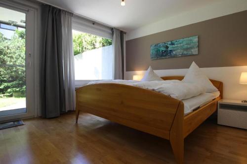 a bedroom with a bed with white sheets and a window at Apartment, Braunlage in Braunlage