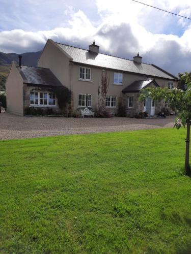 a house with a green lawn in front of it at Croagh Patrick Lodge Apartment in Westport