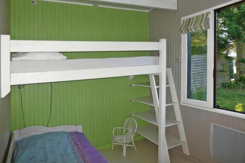 Ce lit superposé se trouve dans un dortoir doté d'un mur vert. dans l'établissement Holiday Home, Portbail, à Portbail