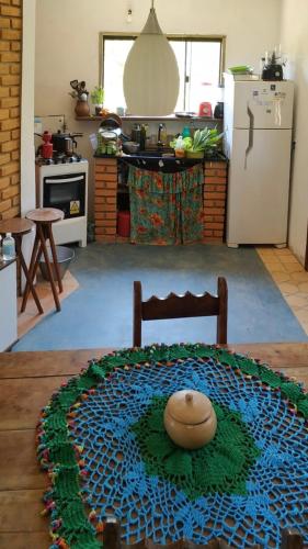 a kitchen with a table with a bowl on top of it at Hospedagem Sabor Da Trilha in Vale do Capao