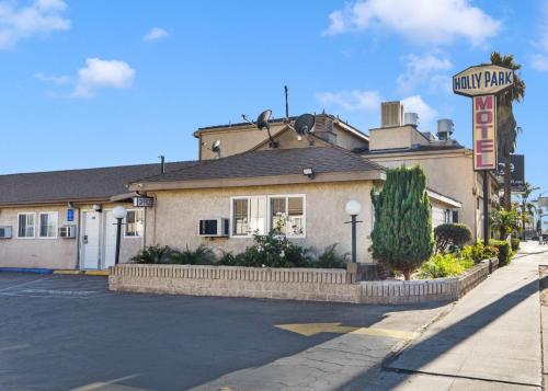 a hotel building with a sign for aury park at Holly Park Motel near LAX in Inglewood