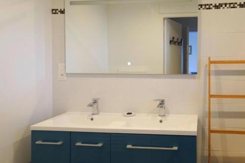 une salle de bain avec un lavabo et un miroir dans l'établissement Cottage by Goëlo Coast with Sea Views, à Paimpol