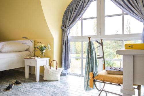 a bedroom with a bed and a large window at Holiday house, Fuhlendorf in Fuhlendorf