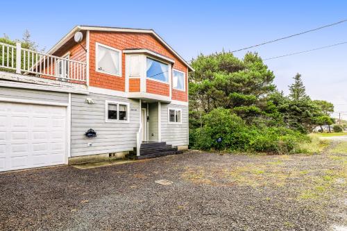a house with an orange and white garage at Harvey's Nedonna Nest in Rockaway Beach